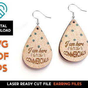 May include: A pair of laser cut wooden earrings with a teardrop shape. The earrings are brown with a light brown wood grain pattern and have a light green polka dot pattern. The earrings have the text "I am here for the commercials" engraved on them.