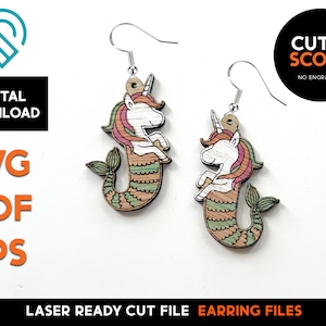 May include: Laser cut file for earrings featuring a unicorn mermaid design. The design is in shades of pink, green, and brown. The file is ready to be cut and scored.