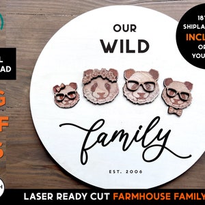 May include: A white round wooden sign with the text "Our Wild Family Est. 2006" in black script. Five laser cut wooden panda bear figures are arranged across the top of the sign. The panda bears have black eyes, noses, and mouths, and some have glasses, bows, and flower crowns. The sign is 18 inches by 11 inches and includes a shiplap backer.