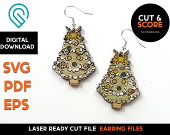 May include: A pair of laser cut wooden earrings shaped like Christmas trees with gold stars and colorful ornaments. The earrings are ready to be assembled and are labeled "Laser Ready Cut File Earring Files".
