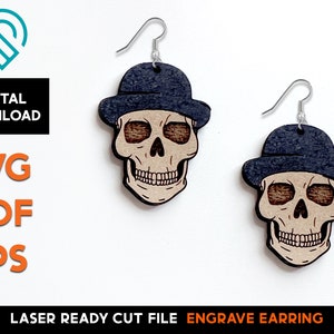 May include: Wooden skull earrings with a dark blue hat. The earrings are laser-cut and feature a detailed skull design. The text "DIGITAL DOWNLOAD" and "SVG PDF EPS" are visible. The words "LASER READY CUT FILE ENGRAVE EARRING" are also present.