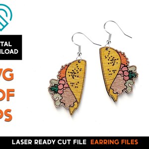 May include: A pair of laser cut wooden earrings featuring a yellow heart shape with a floral design. The earrings are painted with pink, orange, and green colors.