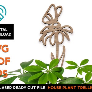 May include: Laser cut wooden flower trellis for house plants. The trellis is shaped like a flower with a butterfly on top. The trellis is brown and the flower is white.