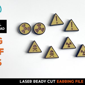 May include: Wooden earring file with various hazard symbols. Includes two round radiation symbols, two exclamation point triangles, two radiation symbol triangles, and two skull and crossbones triangles. The text "DIGITAL DOWNLOAD SVG PDF EPS" is also present.