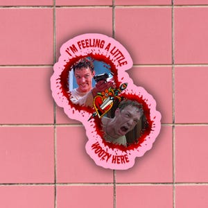 May include: A pink sticker with a red blood splatter design. The sticker features two images of a man from the movie "American Psycho". The text on the sticker reads "I'm feeling a little woozy here".