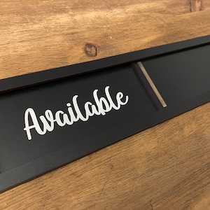May include: Black framed sign with the word "Available" in white lettering. The sign has a blank space for writing.