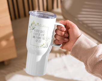 May include: White stainless steel travel mug with a floral design and the text "A little grace, a lot of love, and a heart full of joy!"