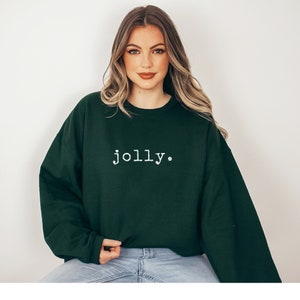 May include: A dark green sweatshirt with the word "jolly" printed in white on the front.
