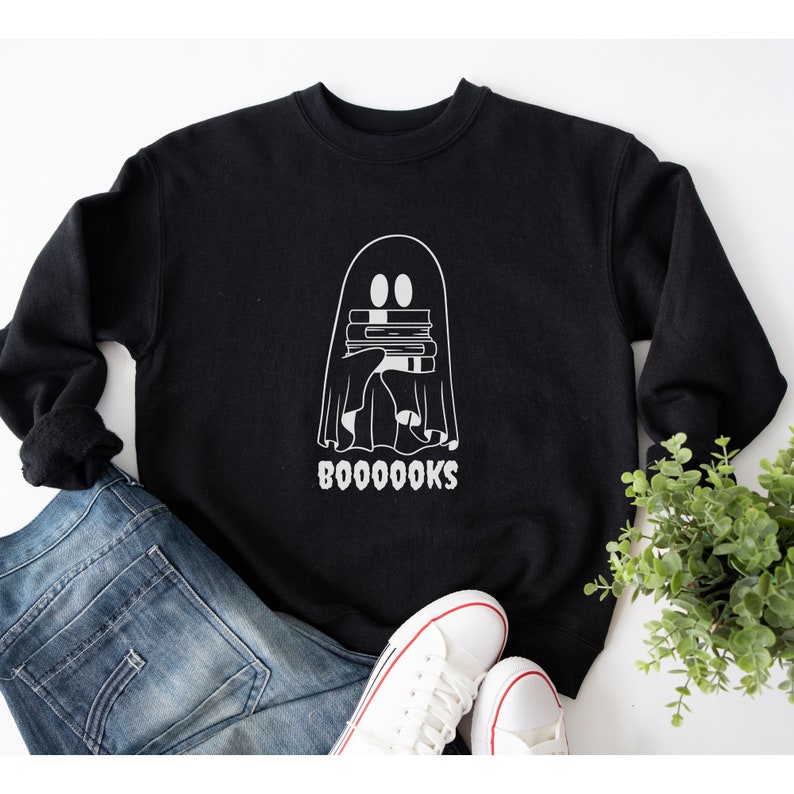 May include: Black sweatshirt with a white ghost holding a stack of books and the text "BOO-OO-OO-OOKS".