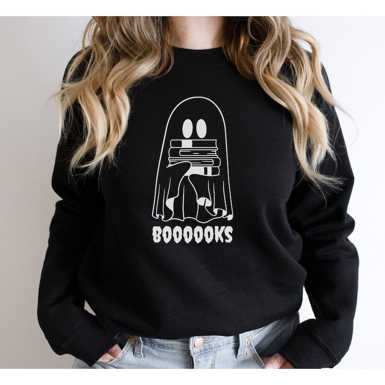 May include: Black sweatshirt with a white ghost holding a stack of books and the text "BOO-OO-OO-OOKS".