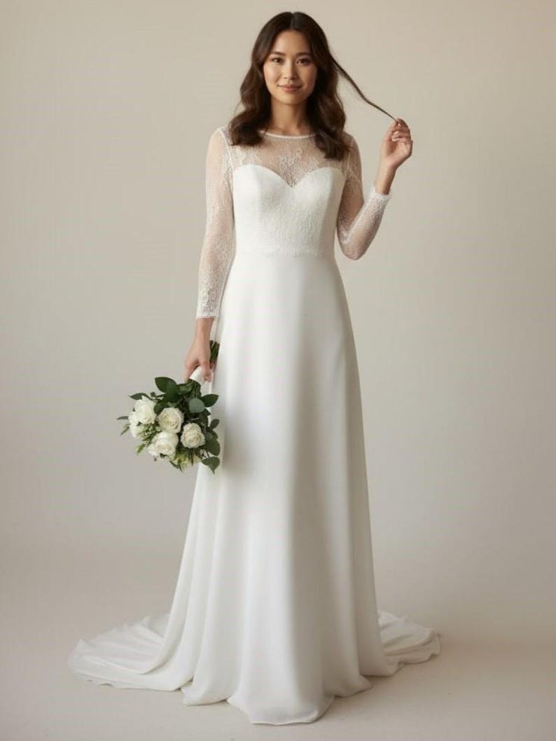 Bride wearing a white lace top with long sheer sleeves, styled as a wedding dress topper lace bolero shrug and floral lace blouse for wedding.