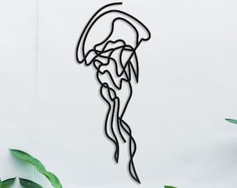 May include: A black line drawing of a jellyfish on a white wall with green plants in the foreground.