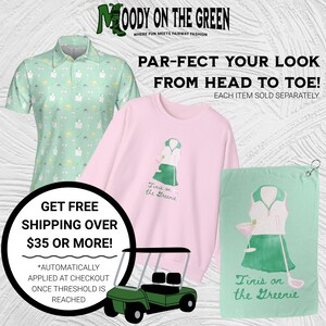 May include: A set of golf-themed apparel and accessories featuring a green and pink color scheme. The set includes a green and white patterned polo shirt, a pink sweatshirt with a graphic of a woman playing golf, and a green towel with a similar graphic. The text "Tinis on the Greenie" is featured on both the sweatshirt and towel. The text "Moody on the Green" is featured at the top of the image. The text "Par-fect your look from head to toe!" is featured in the center of the image. The text "Get Free Shipping Over $35 or More!" is featured in the lower left corner of the image.