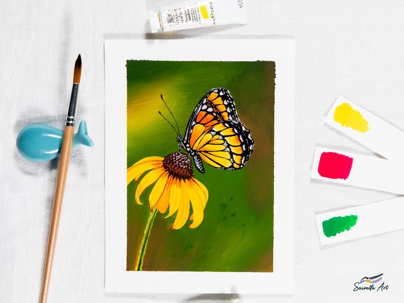 Gouache painting titled 'Flutterby' features a yellow monarch butterfly on a cone flower against a green background. Adds natural elegance to any space.
