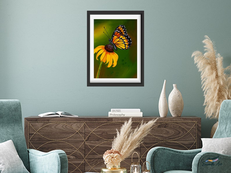 Gouache painting titled 'Flutterby' features a yellow monarch butterfly on a cone flower against a green background. Adds natural elegance to any space.
