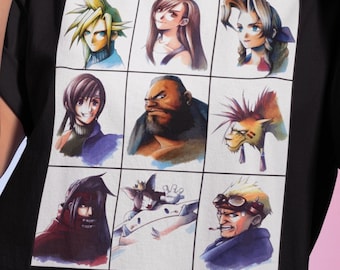 May include: Black t-shirt featuring a grid of nine watercolor portraits of characters from a video game. The portraits include a blonde-haired character, a character with brown hair, and a character with spiky red hair. The shirt is made of a soft material.