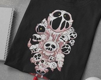 May include: Black t-shirt with a graphic print of a pink, cartoon monster with multiple eyes and mouths. The monster is surrounded by smaller, white, cartoon monsters.