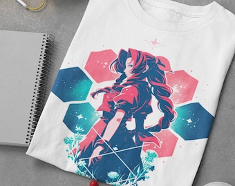May include: White t-shirt with a colorful graphic print of an anime character with long red hair standing in a field of flowers. The character is surrounded by a geometric pattern of pink and blue hexagons.