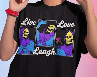 May include: Black t-shirt with a graphic of Skeletor from Masters of the Universe. The graphic shows Skeletor in three different poses with the text "Live, Laugh, Love" above the images.