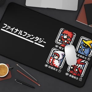 May include: Black mouse pad with the text "Final Fantasy" in white. The mouse pad features four different characters from the game, each with a different job title: Warrior, Black Mage, White Mage, and Red Mage.