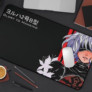 May include: Black and red gaming mouse pad with a white graphic of a woman with purple hair and the text "ヨルハ2号B型 GLORY TO MANKIND".