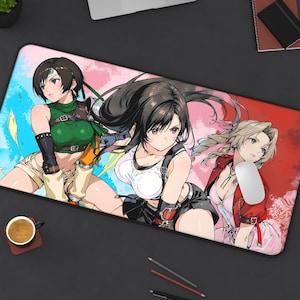 May include: A rectangular mouse mat with anime-style illustrations of three female characters. The artwork has a vibrant colour scheme with blue, pink, and red backgrounds. A computer mouse rests on the right side of the mat.