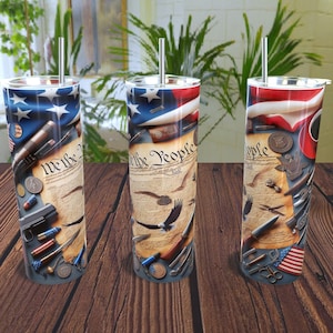 May include: Three stainless steel tumblers with patriotic designs. Each tumbler features a design with the American flag, the text "We the People", eagles, and various historical elements. The tumblers have silver straws.