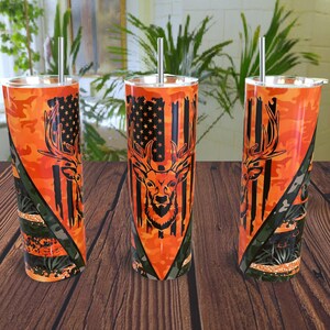 May include: Three stainless steel tumblers with a camouflage pattern and a deer head design. The tumblers are orange, black, and green. Each tumbler has a straw.