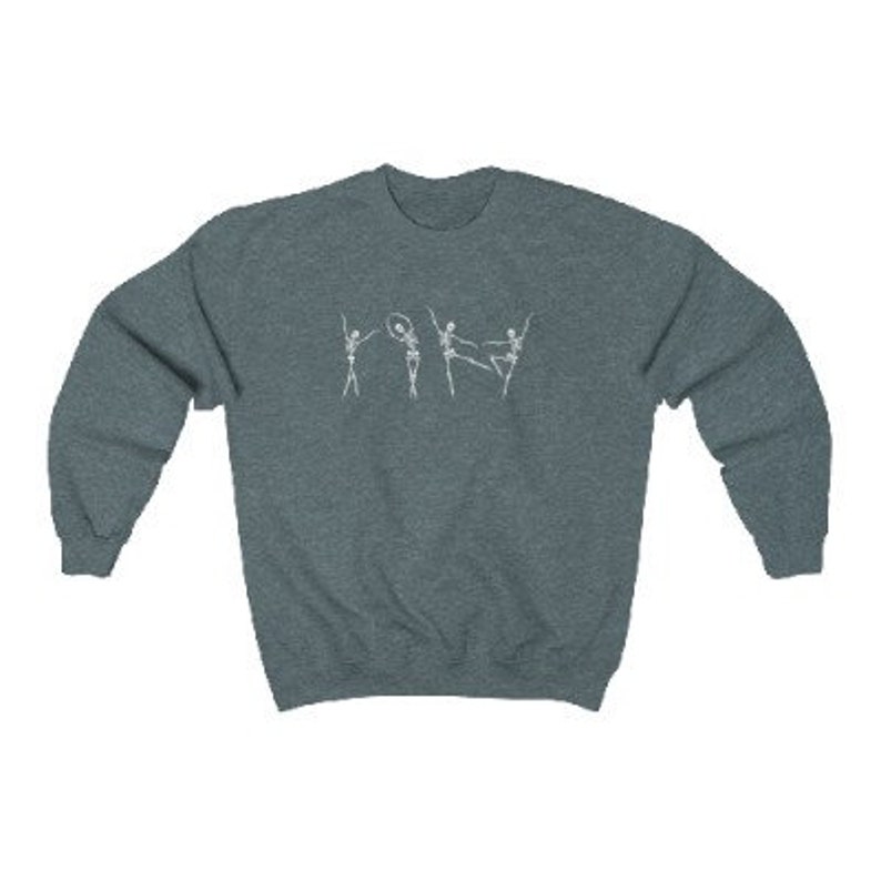 May include: A dark blue sweatshirt with a white graphic of five skeletons dancing. The skeletons are in various poses, including one holding a hoop.