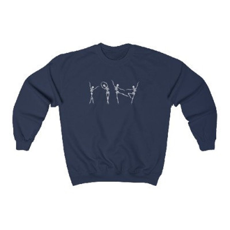 May include: Navy blue sweatshirt with a white graphic of four skeletons dancing. The skeletons are wearing tutus and one is holding a hoop.