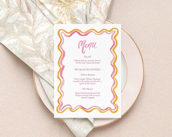 May include: A white menu card with a pink and gold border. The menu card has the word "Menu" written in cursive at the top. The menu lists "Salad", "Pre-Selected Entrees", "Chicken Sandwich", "Fish", "Filet Mignon", and "Green and Corn Coast Flat".