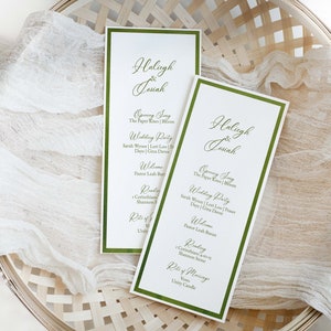 May include: Two wedding ceremony programs with green borders and white paper. The programs list the order of the ceremony, including the opening song, wedding party, welcome, readings, and the rite of marriage. The programs are titled "Haleigh & Josiah".