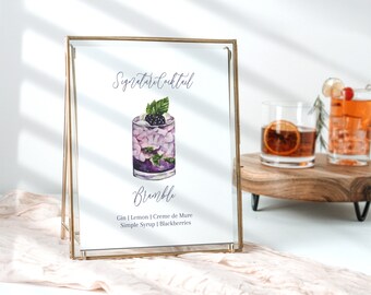 May include: A gold-framed sign with a watercolour illustration of a cocktail called "Bramble". The sign reads "Signature Cocktail" and lists the ingredients: Gin, Lemon, Creme de Mure, Simple Syrup, Blackberries.