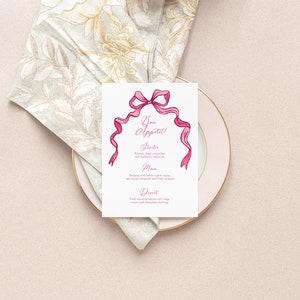 May include: A white menu card with a pink ribbon design. The menu card has the text "Bon Appetit!" and lists "Starters", "Main", and "Dessert" with sample menu items.