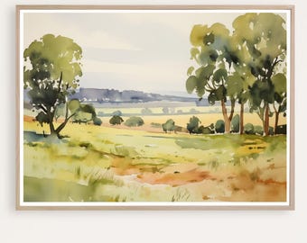 May include: Watercolor landscape art print featuring a serene countryside scene. The artwork showcases a field of yellow and green grass, with trees and a distant mountain range. The painting is framed in a light wood frame.