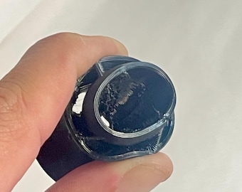 May include: Close-up of a black 3D printed object with a circular opening and a visible internal structure.