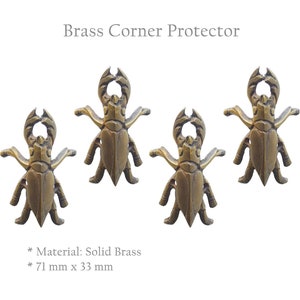 May include: Four solid brass corner protectors shaped like beetles. Each protector measures 71 mm by 33 mm.