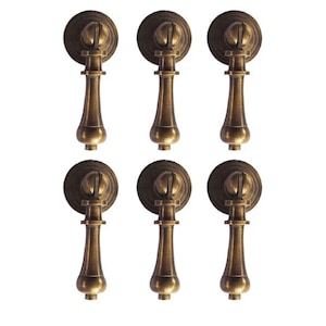 May include: Six antique brass cabinet pulls with a classic design. Each pull features a round backplate, a decorative stem, and a teardrop-shaped handle. The pulls are arranged in two rows of three against a white background.