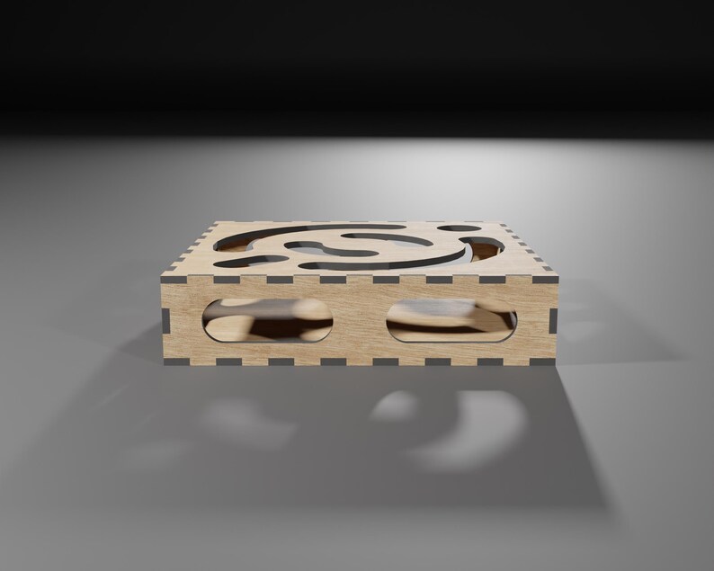 Puede incluir: Una caja de madera con un dise&ntilde;o recortado en forma de espiral. La caja est&aacute; hecha de madera marr&oacute;n claro y tiene un borde marr&oacute;n oscuro.