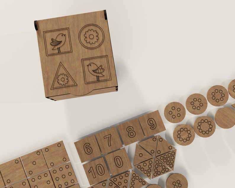 May include: Wooden box with a bird, flower, and triangle design. The box is open and contains a set of wooden tiles with numbers, circles, and a pie shape.
