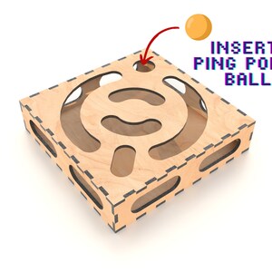 Puede incluir: Laberinto de madera con un recorte en forma de c&iacute;rculo. El laberinto est&aacute; dise&ntilde;ado para que una pelota de ping pong se inserte en el c&iacute;rculo y se navegue a trav&eacute;s del laberinto. El texto "INSERT PING PONG BALL" est&aacute; escrito sobre el laberinto.