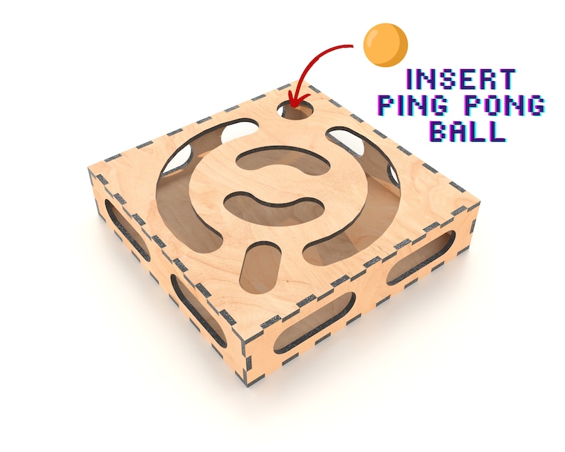 Puede incluir: Laberinto de madera con un recorte en forma de c&iacute;rculo. El laberinto est&aacute; dise&ntilde;ado para que una pelota de ping pong se inserte en el c&iacute;rculo y se navegue a trav&eacute;s del laberinto. El texto "INSERT PING PONG BALL" est&aacute; escrito sobre el laberinto.