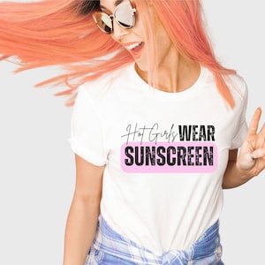 May include: White t-shirt with the text "Hot Girls Wear Sunscreen" in black with a pink rectangle behind the text.