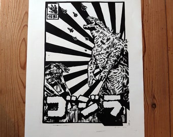 May include: Black and white woodblock print of a Godzilla-like monster with a Japanese text logo that reads "Gojira". The monster is standing in front of a rising sun with a background of stylized fighter jets.