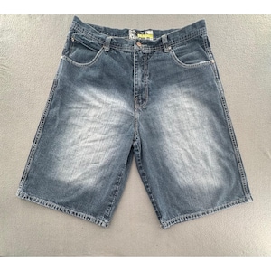 May include: Blue denim shorts featuring a faded wash effect, a button and zipper fly closure, five pockets, and visible contrast stitching. The waistband includes belt loops and a small rectangular brand label centered at the back.