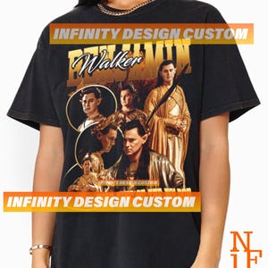 May include: Black t-shirt with a vintage-style graphic featuring a group of people with the text "Walker" and "INFINITY DESIGN CUSTOM" printed on the front.