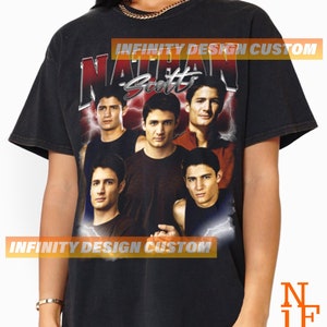 May include: Black t-shirt with a vintage-style graphic of a group of men with the text "Nathan Scott" above them. The graphic is surrounded by lightning bolts.