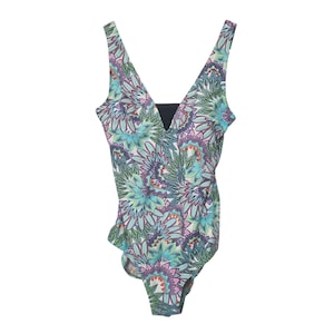 May include: A one-piece swimsuit featuring a vibrant, multi-colored floral and mandala-inspired pattern in shades of teal, purple, green, and white. The garment has a deep V-neckline with a solid black fabric insert at the center of the chest.