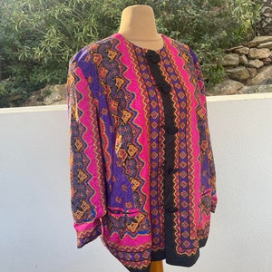 May include: A long-sleeved button-up jacket with a colourful paisley pattern in shades of pink, purple, blue, gold, and black.