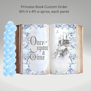 May include: A large, open book backdrop with a white background and blue floral designs. The book is open to a page with the text "Once upon a Time" and a drawing of a castle. The book is 6 feet tall and 4 feet wide.